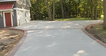 Homeowner's Concrete Driveway with Colored Concrete Edging | Residential Concrete Services
