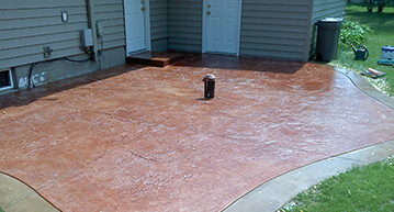 Colored and stamped concrete backyard patio | Decorative Concrete Services
